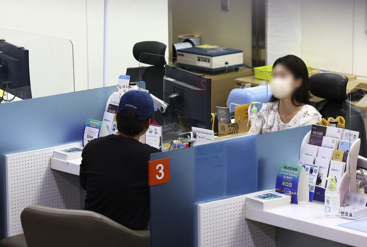 은행 창구에서 대출 상담을 받는 시민, 햇살론과 신규 서민대출 비교